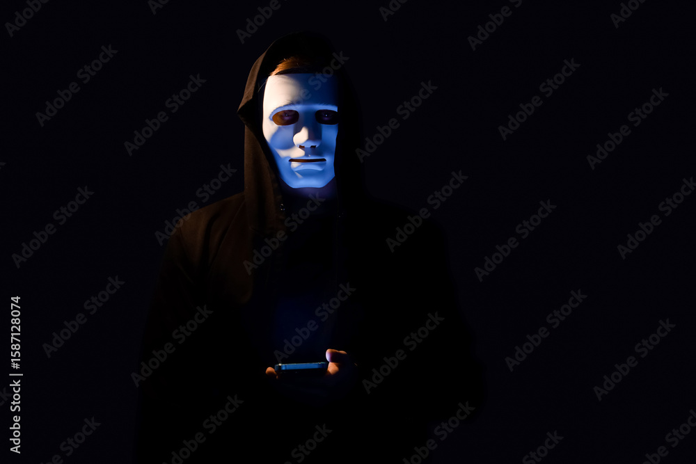 Aufkleber hacker with mobile phone on dark background