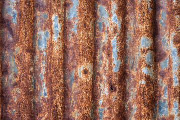 An old rusty metal sheet roof textured. Rust is an iron oxide formed by the reaction of iron and...