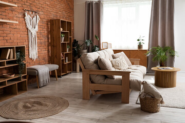 Comfortable sofa and shelving unit in interior of living room