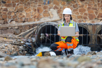 Environmental Engineer Testing Water Quality by Culvert, Scientist or Technician Monitoring Water...