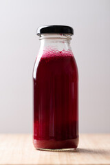 Fresh beetroot juice in bottle on wooden board, Healthy drink