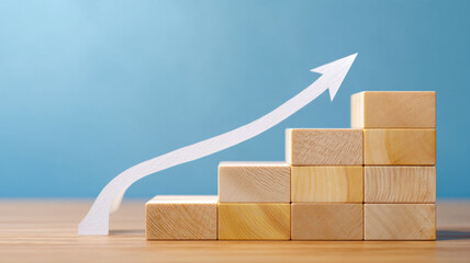 Wooden blocks forming stairs with an upward trending arrow