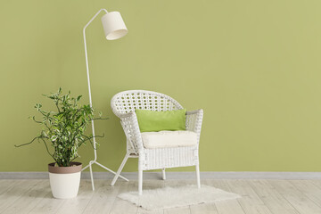 Interior of living room with lamp, armchair and plant