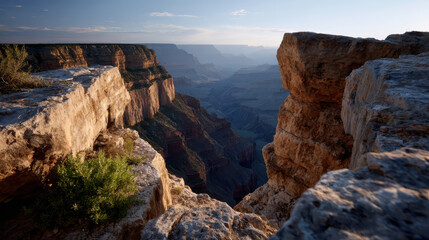 Obraz premium Majestic canyon landscape with rugged rock formations and deep valleys under clear sky, evoking sense of adventure and tranquility