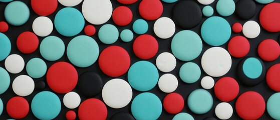 Pattern of colorful dots and circles in red, blue, white, and black creates vibrant and playful abstract background