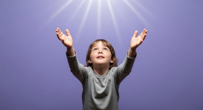 Photo of a joyful child with hands raised towards the light, looking up with a happy expression, symbolizing hope, faith, and spiritual connection against a purple background