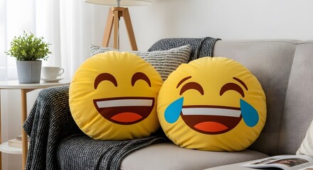 Two plush emoji pillows, depicting happy and crying faces, resting on a couch in a living room.