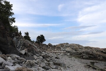 Coastline and geology formation. Rocks and pines on a riverside in Charlevoix in Quebec. Charlevoix landscape and travel.