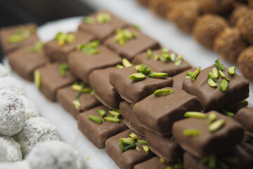 Delicious chocolate sweets with pistachio nuts on display