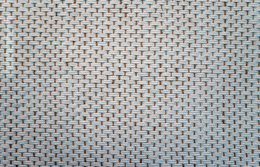 White Pattern of Weaving on a Tan Background with Detail and Texture.