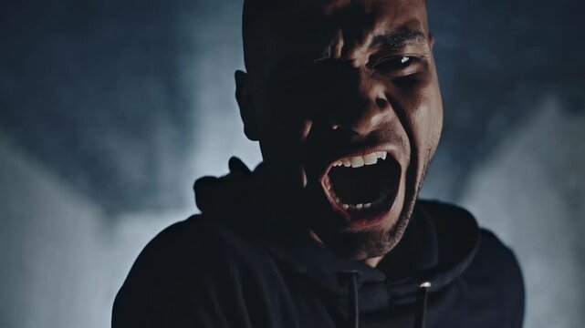 A man expressing a silent scream, capturing deep emotional stress and inner turmoil. Concept of mental health, anxiety, and an unspoken cry for help. Powerful emotional portrait