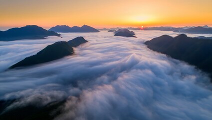 Fototapeta premium Serene sunrise scene with mountains and floating clouds above.