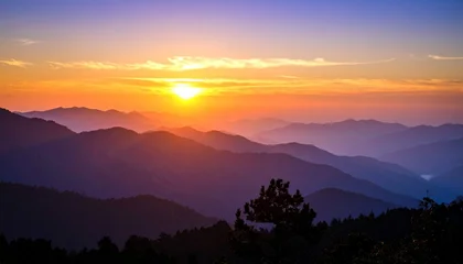 Fototapete Sonnenuntergang A vibrant sunset over a layered mountain range, casting a warm glow on the landscape.  © Rupa