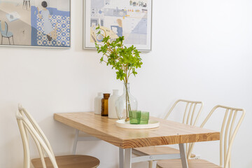 Modern dining room with wooden table and decorative plants