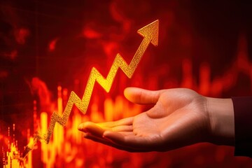 Golden arrow pointing upward rests on a hand, symbolizing financial growth, success, and positive market trends in a vibrant red and orange background.