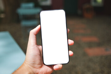 Mockup image of a man holding mobile phone with blank screen in the outdoors