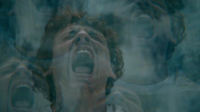 Young man screaming in intense mental anguish, experiencing psychotic episode in asylum ward. Kaleidoscope effect