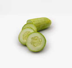 Sliced fresh cucumbers on white background, perfect for healthy eating, vegan recipes, food blogs, detox diet, kitchen ingredients, organic vegetables, and minimal food photography. High resolution.