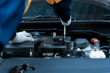 Asian male automotive technician who inspects, repairs, and maintains all vehicle systems,ensuring...