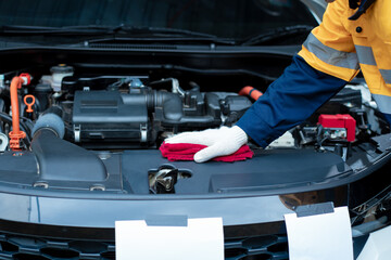 Asian male automotive technician who inspects, repairs, and maintains all vehicle systems,ensuring...