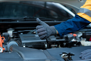 Asian male automotive technician who inspects, repairs, and maintains all vehicle systems,ensuring...