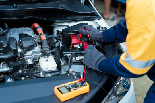 Asian male automotive technician who inspects, repairs, and maintains all vehicle systems,ensuring safe and optimal performance through expertise in engines, brakes, transmissions electrical systems