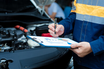 Asian male automotive technician who inspects, repairs, and maintains all vehicle systems,ensuring...