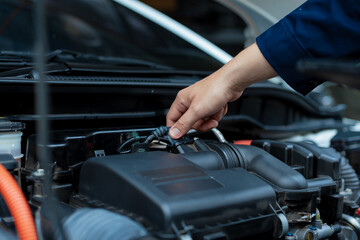 Asian male automotive technician who inspects, repairs, and maintains all vehicle systems,ensuring...