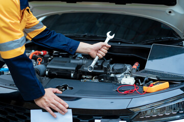 Asian male automotive technician who inspects, repairs, and maintains all vehicle systems,ensuring...
