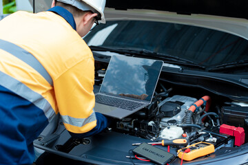 Asian male automotive technician who inspects, repairs, and maintains all vehicle systems,ensuring...