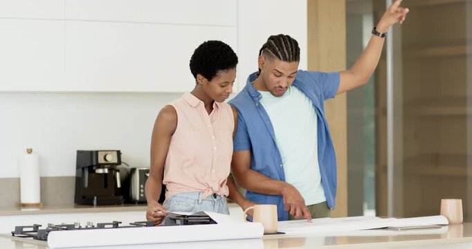 Diverse couple triggered by unrolled blueprints pointing and tracing kitchen island layout with pen