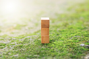 3 stacking square empty wooden cubes with green natural background and blur for own customer text or letters. Idea of environment, energy or business concept. Front view, banner copy space.