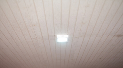 Light bulbs are installed on the white wooden ceiling.