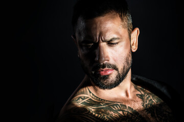 Obraz premium Serious man with confident look. Handsome male model portrait. Guy strong emotion. Sexy man portrait. Closeup of thoughtful male face. Confident man posing. Young man looking serious and focused.