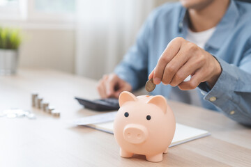 Saving money wealth concept, asian young business man hand putting coin into piggy for saving cost,...