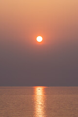 The sun above the sea at sunset. sparkling ripple, sun glitter, water shimmering