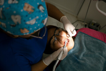 Dentist performing dental procedure on patient's teeth
