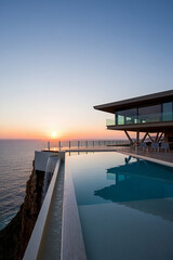 Sunset view of a pier over calm sea with colorful sky