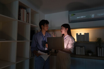 Professional Collaboration. Young colleagues discussing project details with a laptop in a modern...