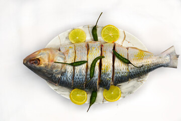 Indian fish fry recipe- fresh whole Hilsa fish or Ilish fish or Poplet cut into slices. cleaned and...