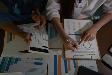 Data Review. Young professionals analyzing financial reports together in office.