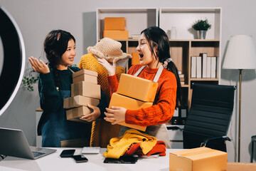 Portrait of Starting small businesses SME owners, two Asian woman check online orders Selling...