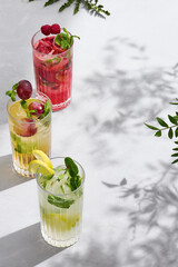 Summer lemonades in tall glasses, bright natural lighting, overhead composition with empty space