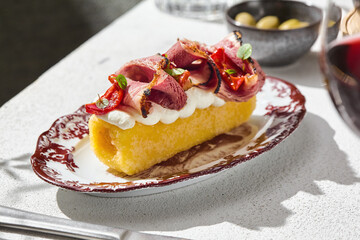 Baked polenta with roast beef, bright natural light, closeup composition, summer Hungarian menu presentation