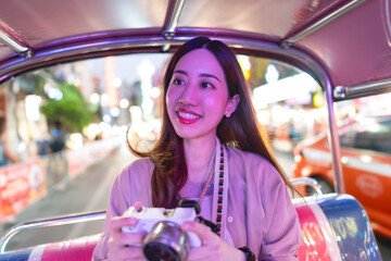 Solo traveler smiling face adult woman sitting tuk tuk taxi local tour explore street journey...