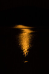 Shimmering orange glow of a moonrise on Mountainview Lake.