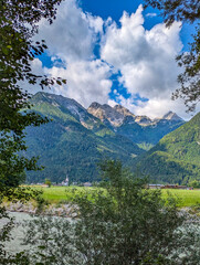 River Saalach in Salzburger Land, Austria, with a view of the Catholic parish church of St. Martin...