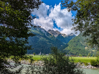 River Saalach in Salzburger Land, Austria, with a view of the Catholic parish church of St. Martin...