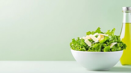 Fresh caesar salad with parmesan and croutons beside olive oil bottle