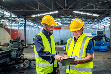 Two professional engineer worker technician assistant in helmet inspection check old machine...